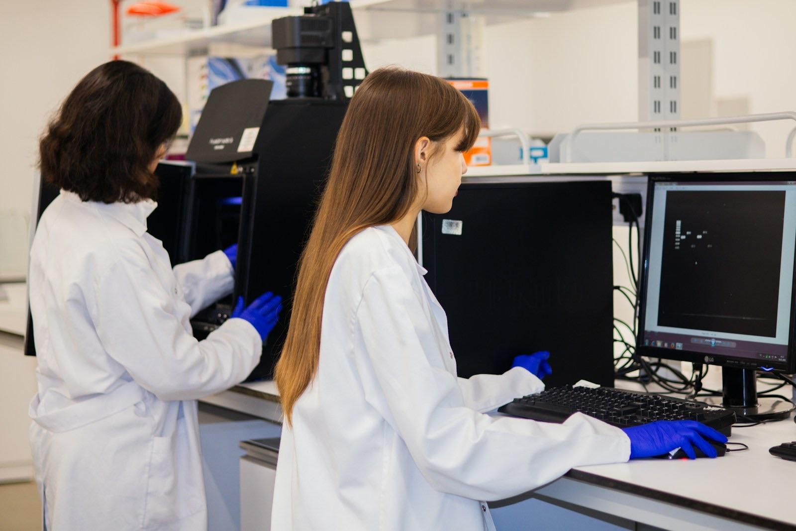 Scientists collaborating with digital technology in a laboratory environment