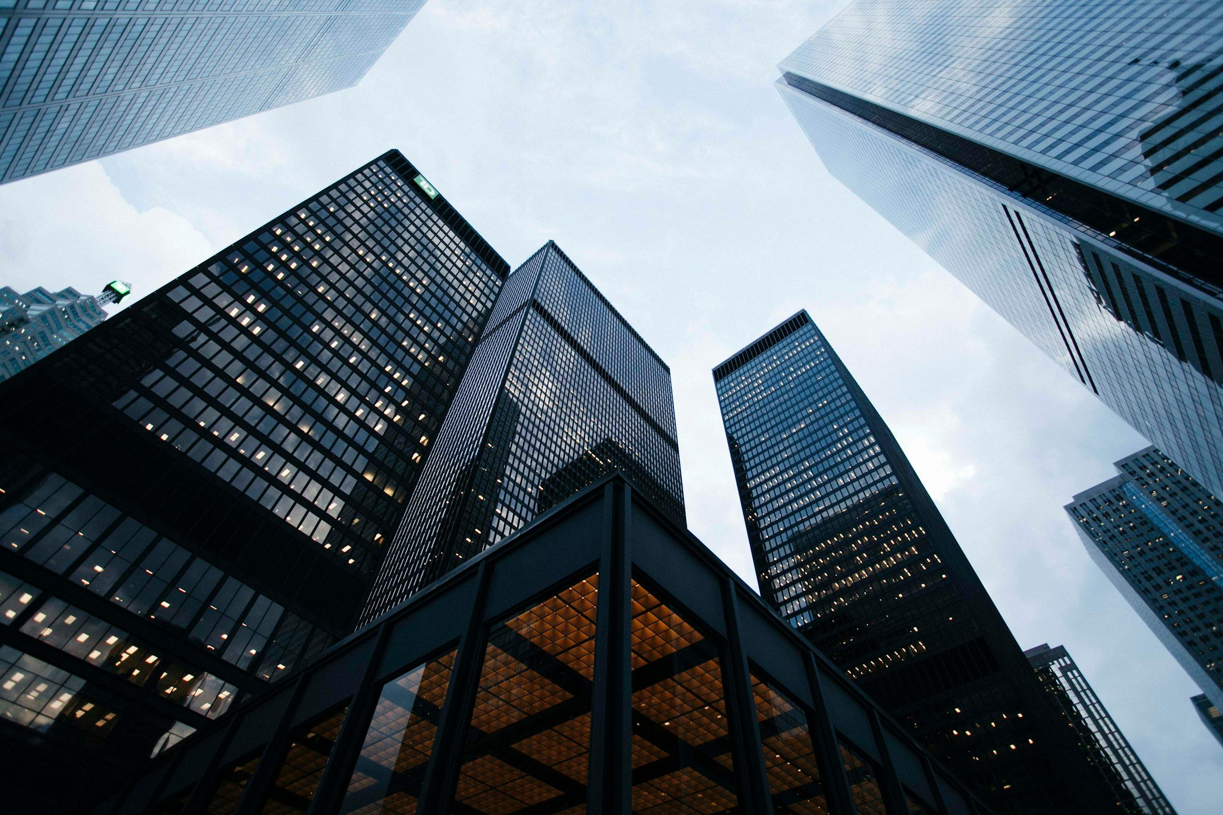 Modern glass high-rise buildings viewed from below against the sky